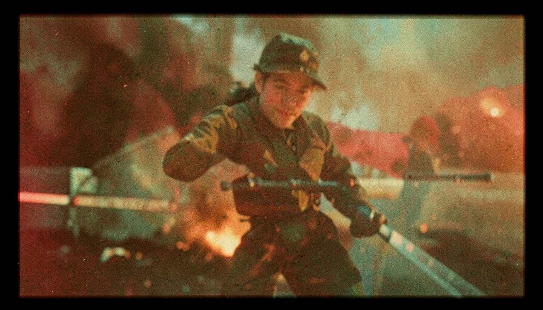 Warm-toned grainy film frame in amber and teal, suggesting a dramatic Hollywood action scene.